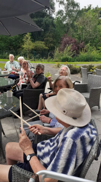 Residents playing instruments outside in the garden