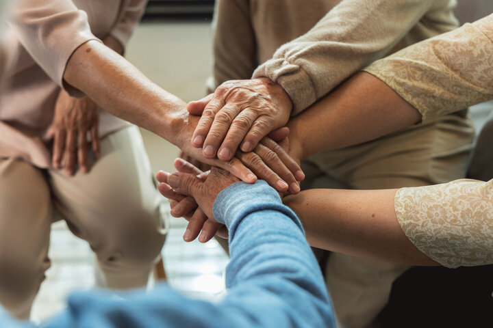 hands in a circle overlapping