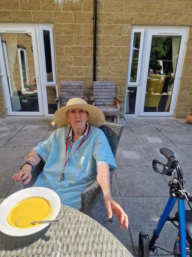 resident enjoying soup in the garden