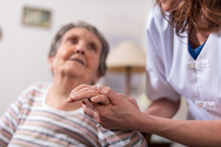 older woman in wheelchair at a care home